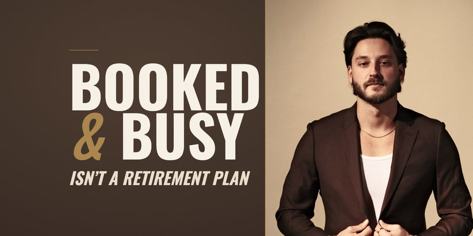 Barber and educator Tyler Carlson in a chocolate-brown suit jacket against a tan studio backdrop, beside the words Booked and Busy Isn’t a Retirement Plan on a chocolate-brown field.